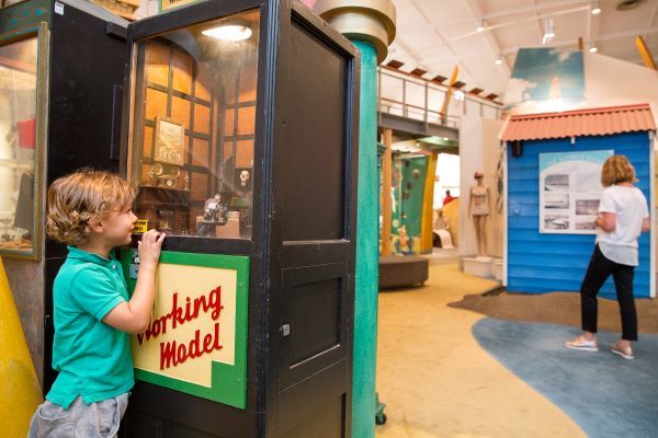 child peering in arcade game