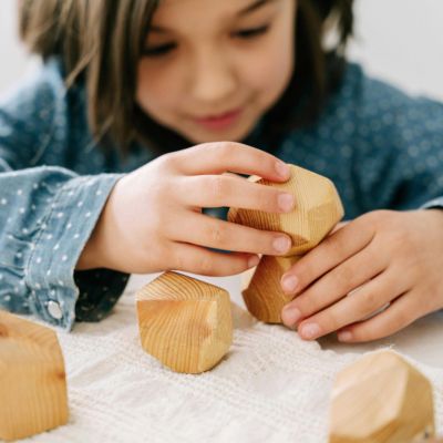 young child playing with wooden blocks