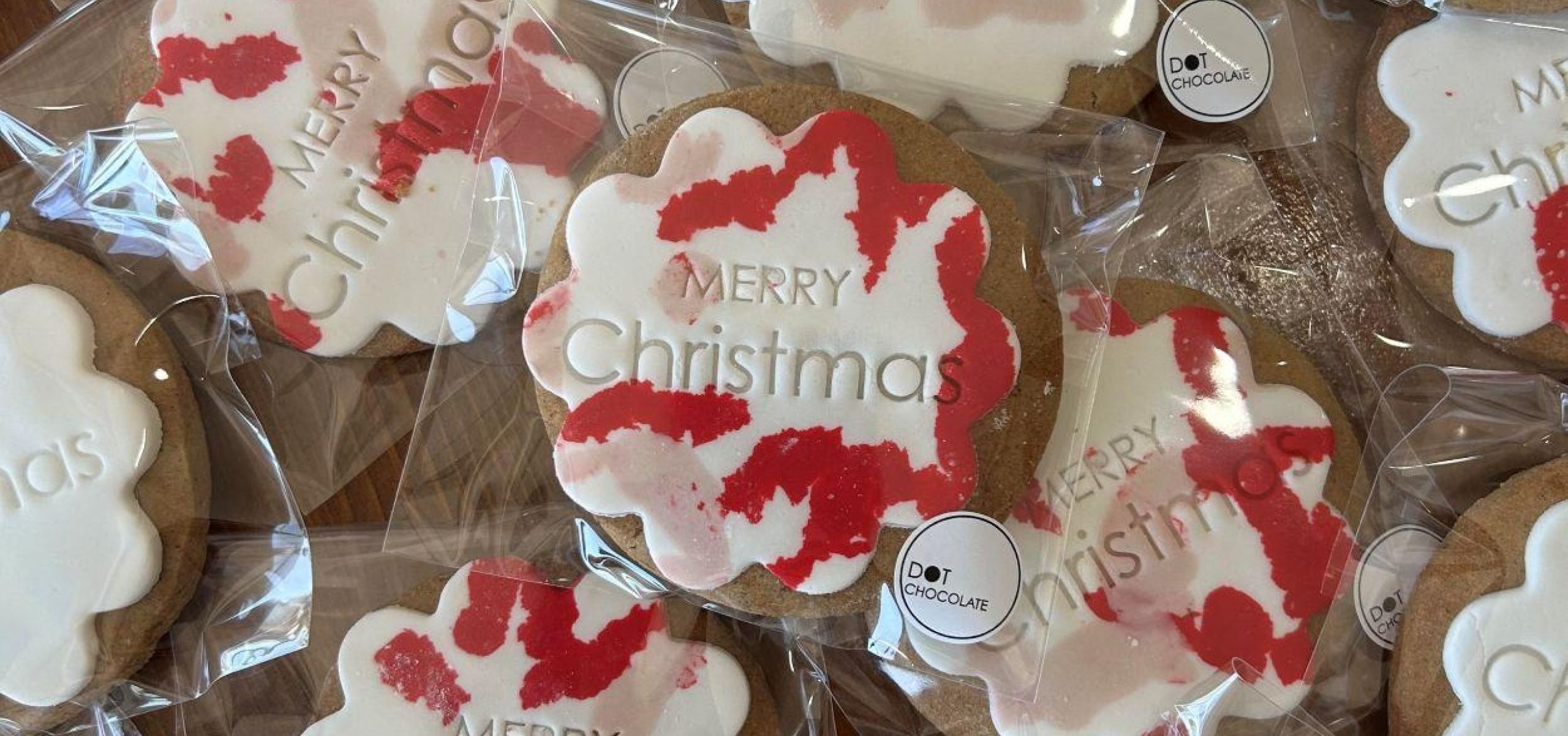 Collection of individually wrapped biscuits with Christmas themed fondant icing.