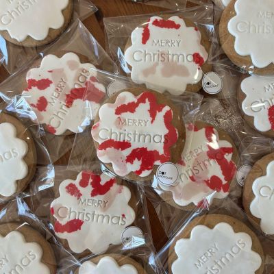 Collection of individually wrapped biscuits with Christmas themed fondant icing.