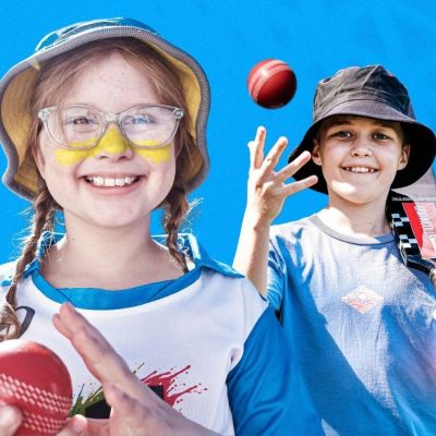 Two children holding cricket balls
