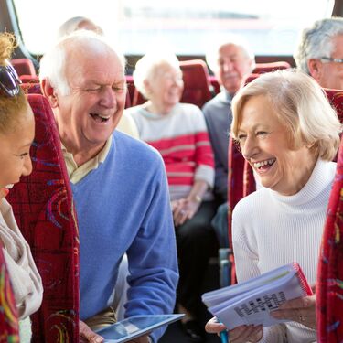 three people on a bus laughing