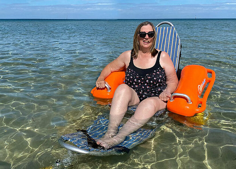 Person using floating wheelchair at the beach