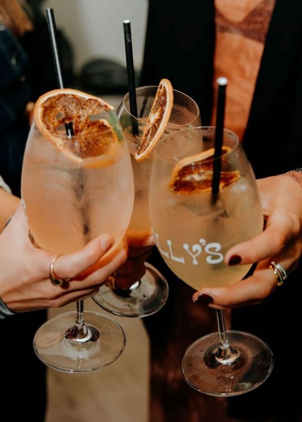 People toasting with drinks in hand