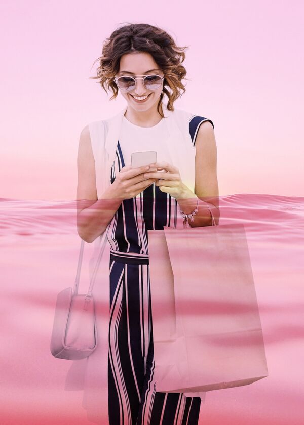 Woman shopping while looking at mobile phone