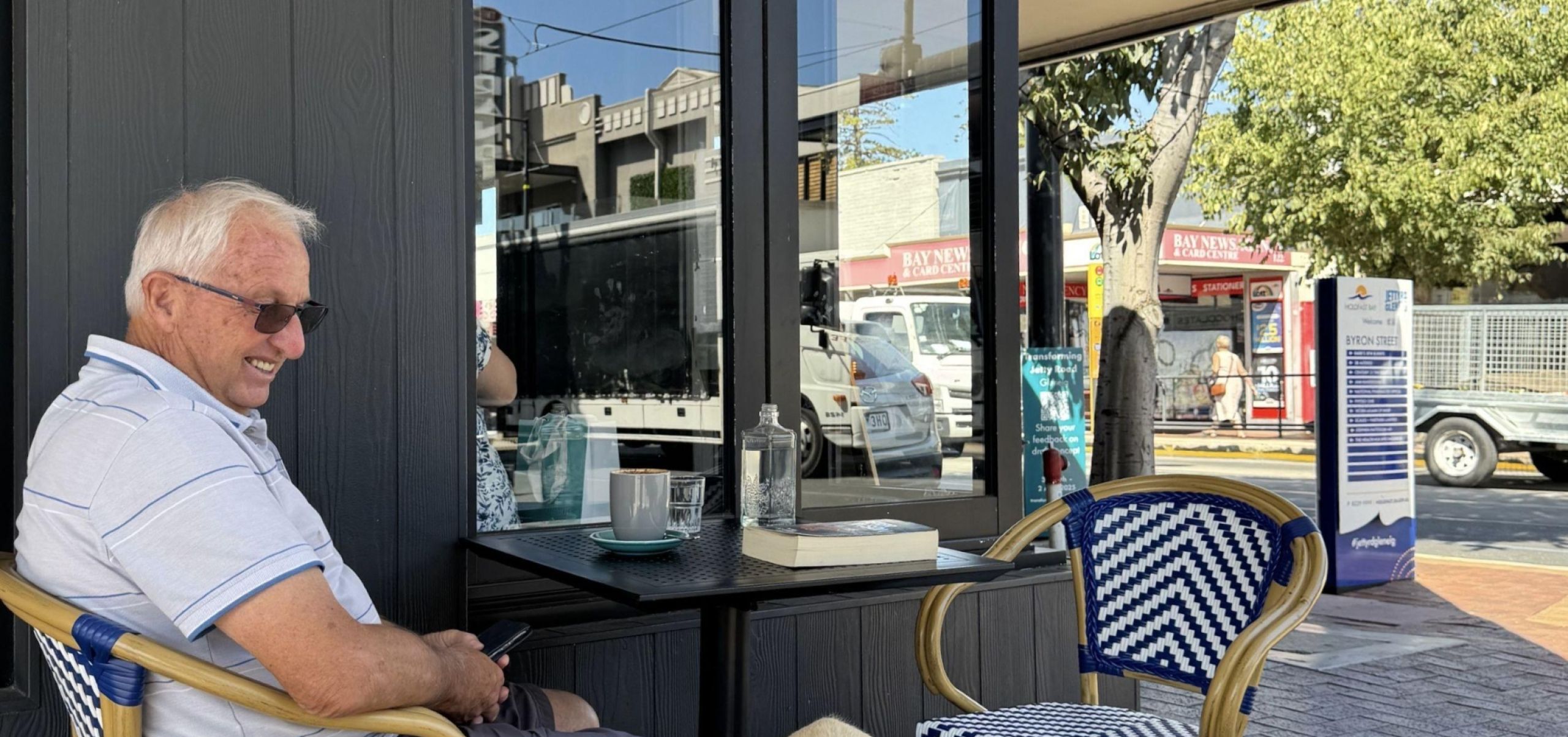 Man with dog outside cafe