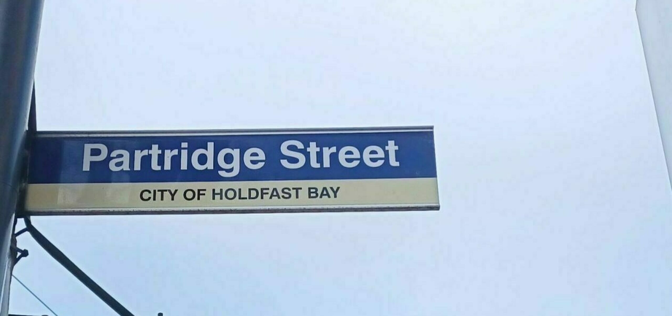 Partridge Street, street sign in front of a blue sky