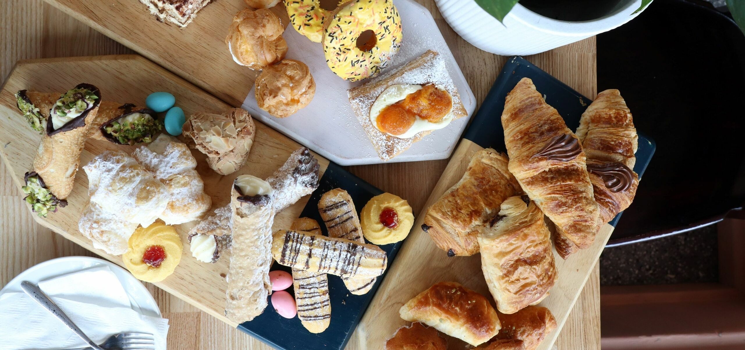 cakes and pastries on three serving boards