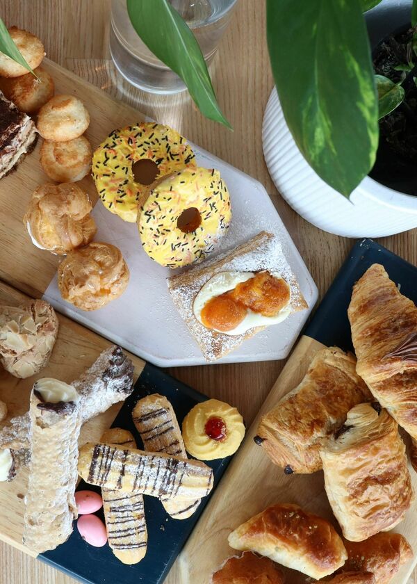 cakes and pastries on three serving boards