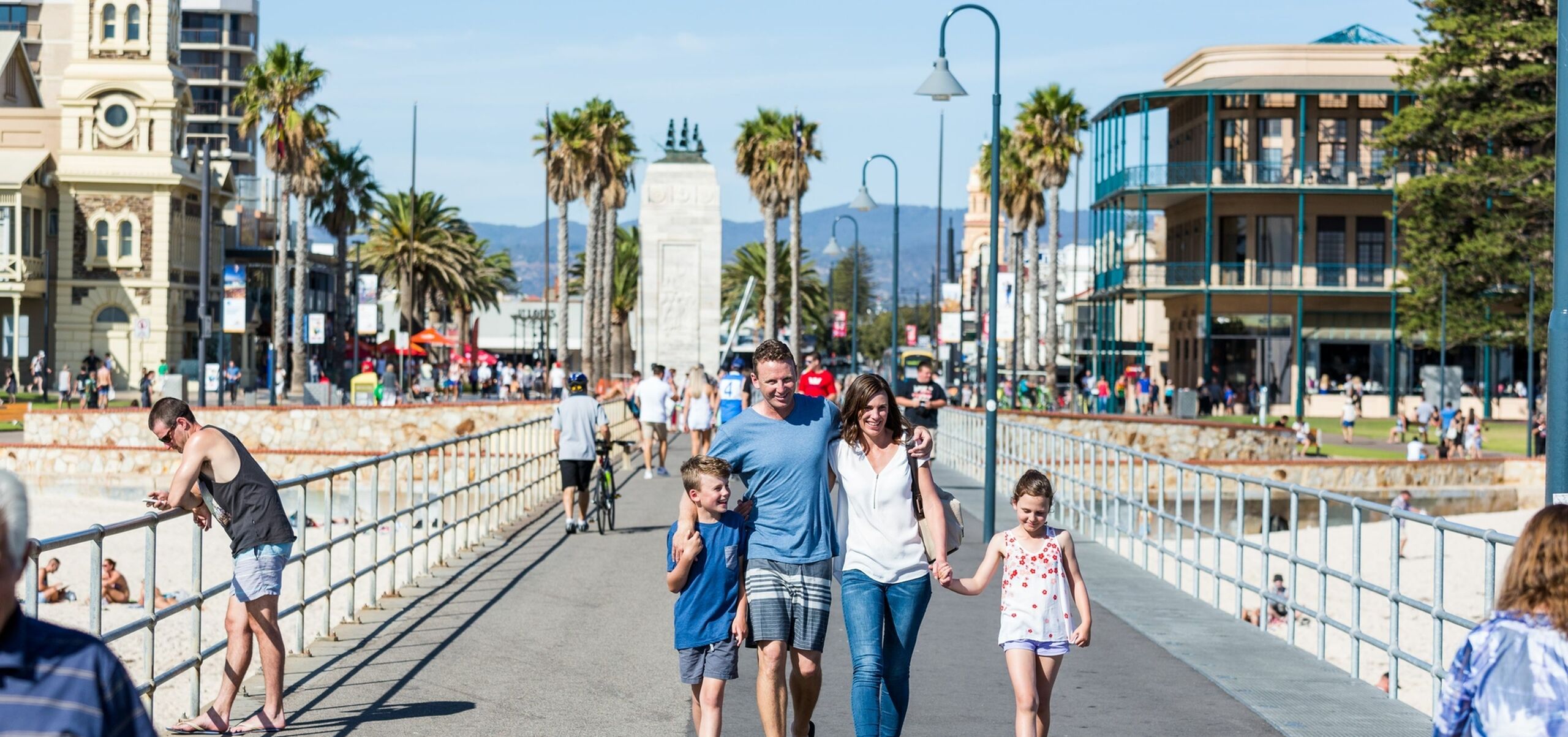 Family of four walking along the Jetty in Glenelg