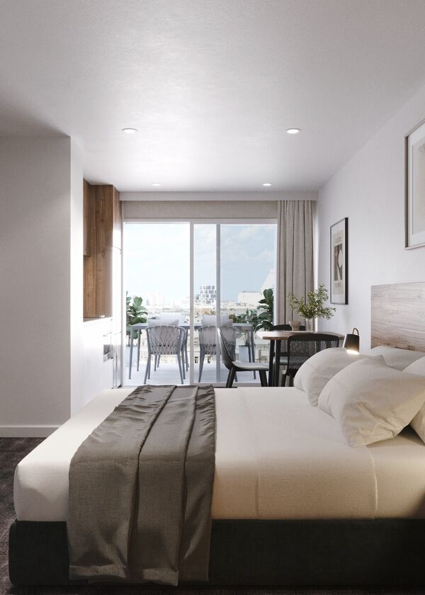 white bed with a sliding door in the background