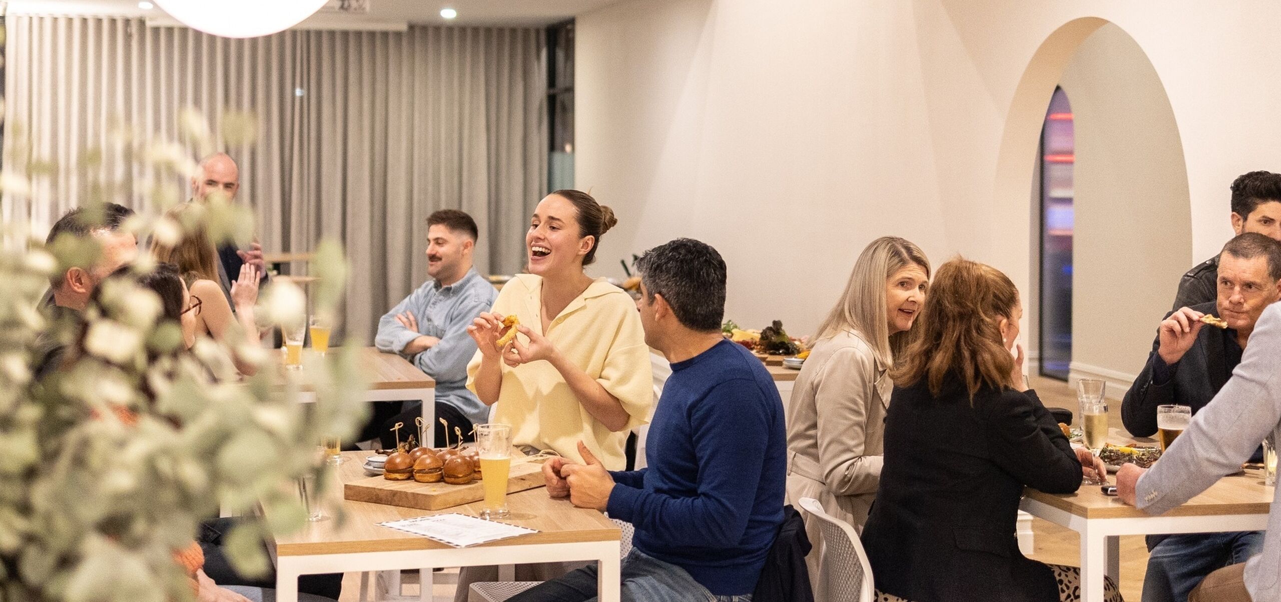 Large group of people eating and chatting