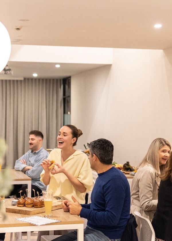 Large group of people eating and chatting