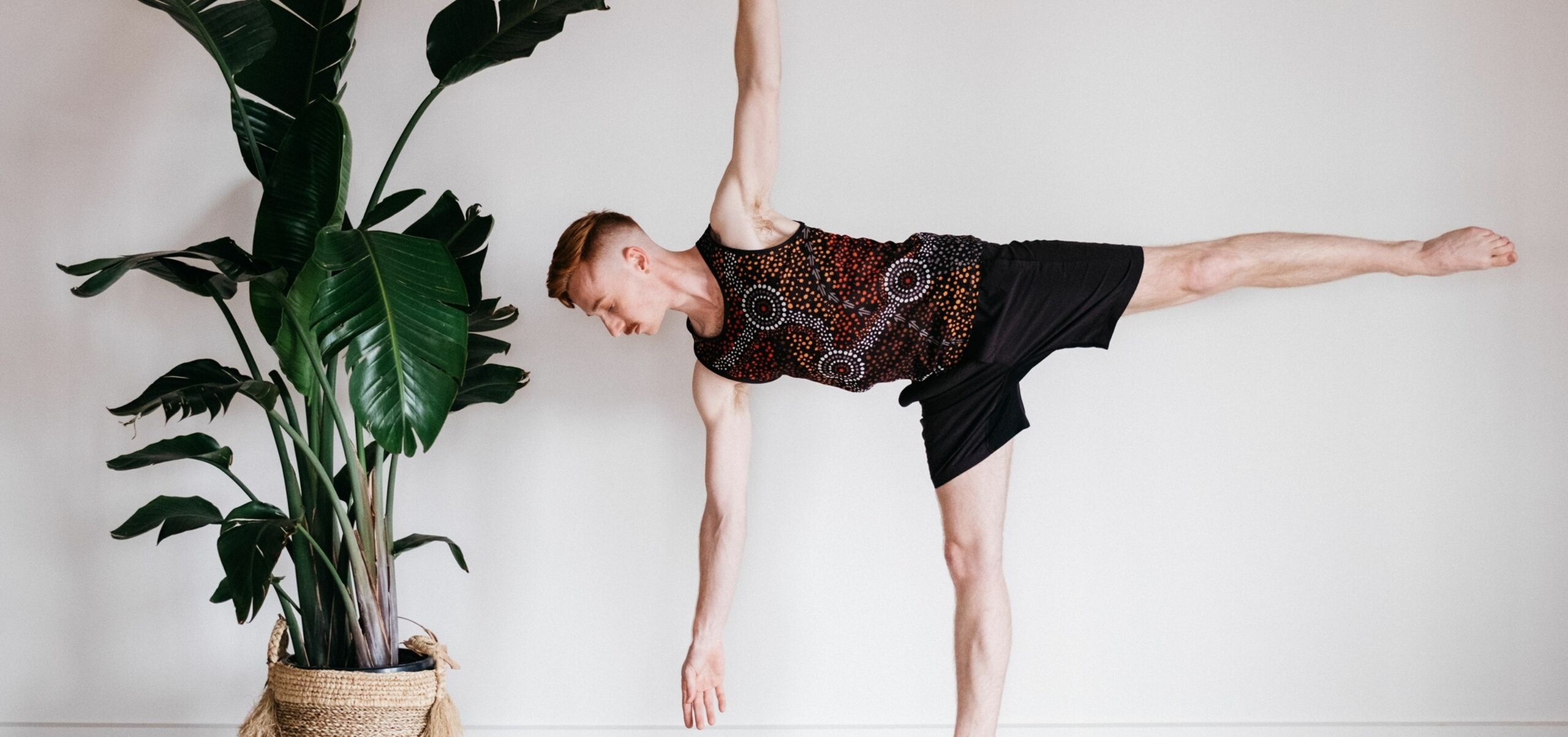 Person in a yoga pose, balancing on one leg