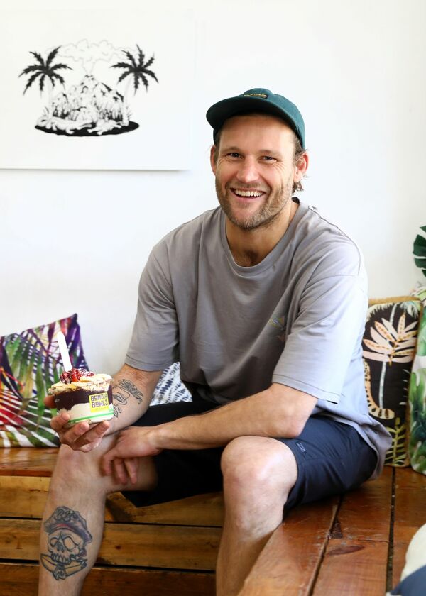 Dale smiling at the camera and sitting on a bench