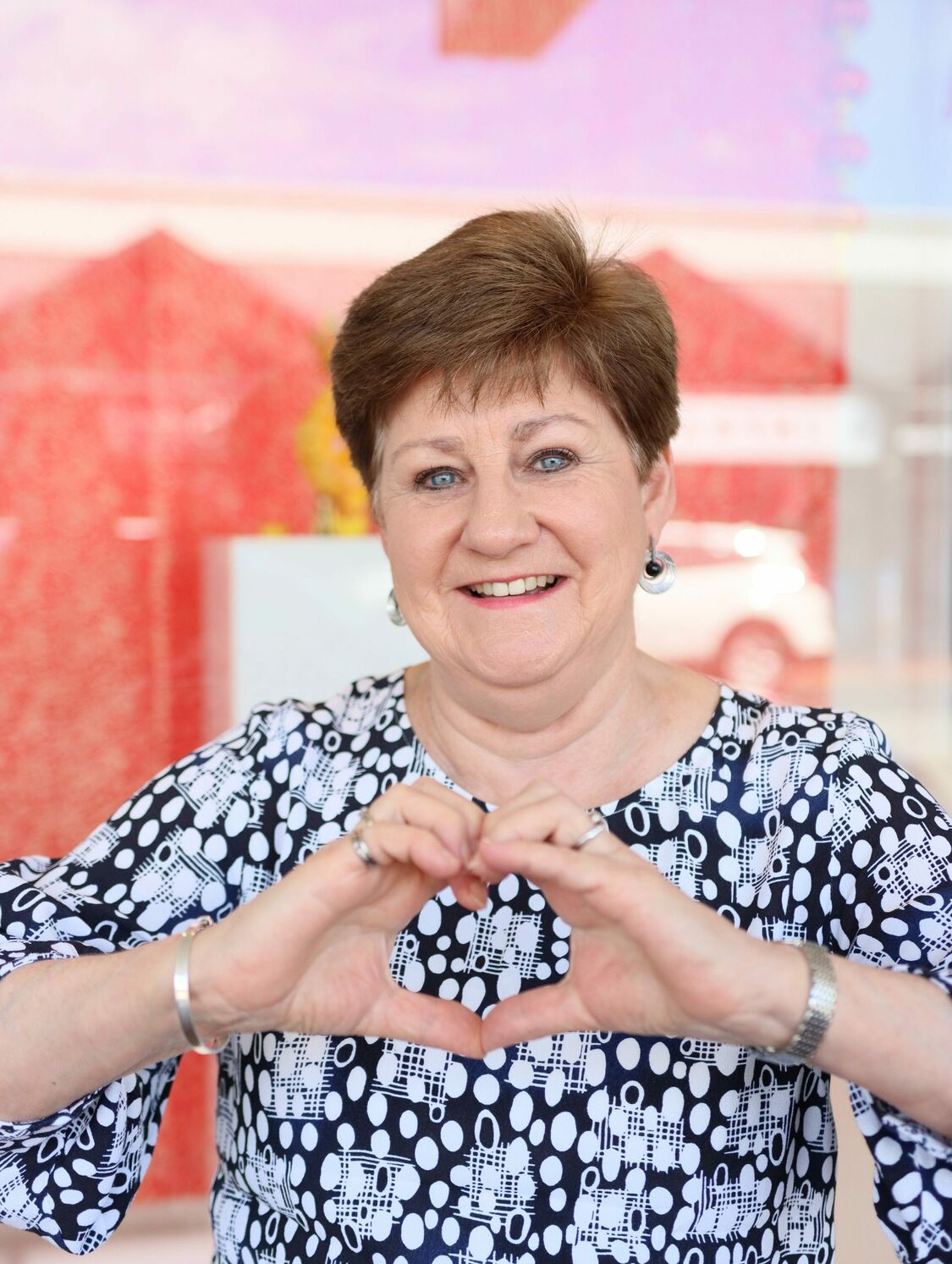 Joanne from Holdfast Bay Optometry making a heart shape with her hands