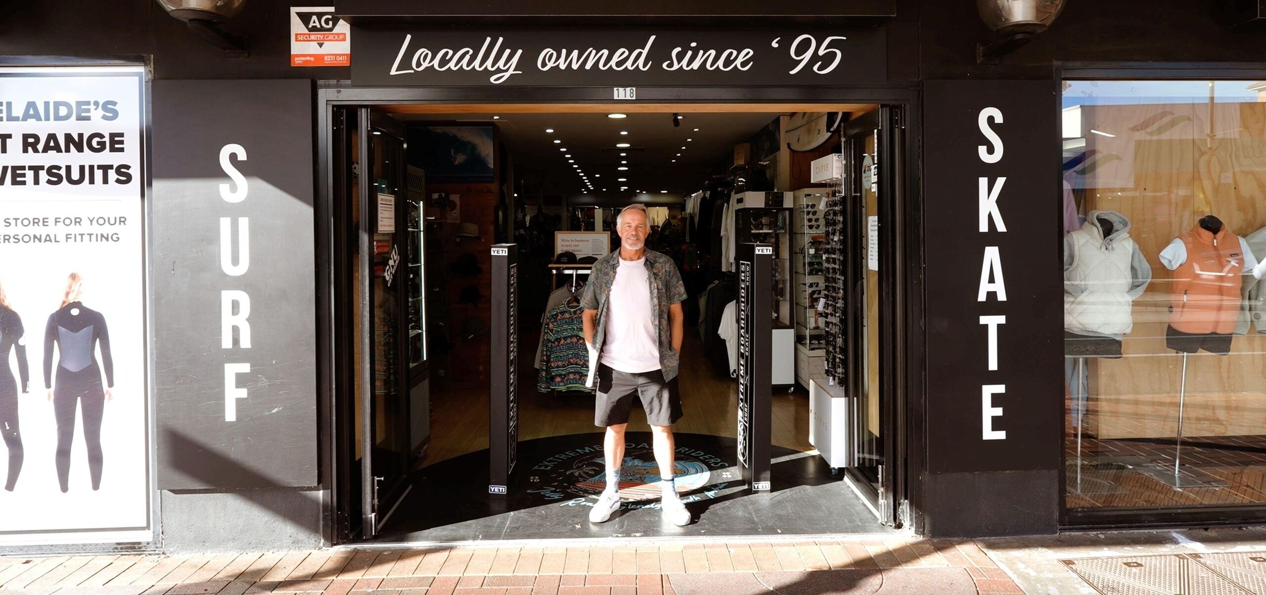 Greg standing in front of a surf shop