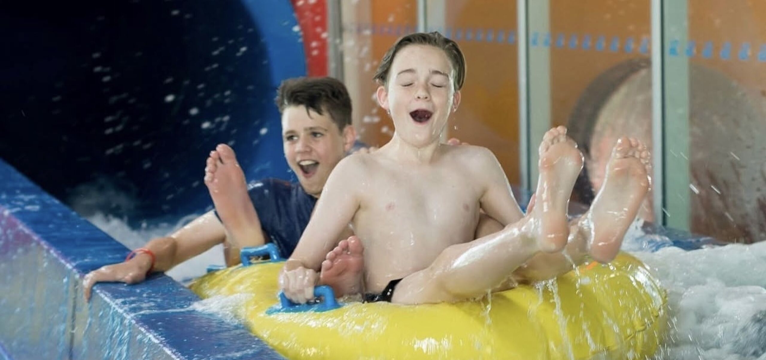 Two boys on water slide