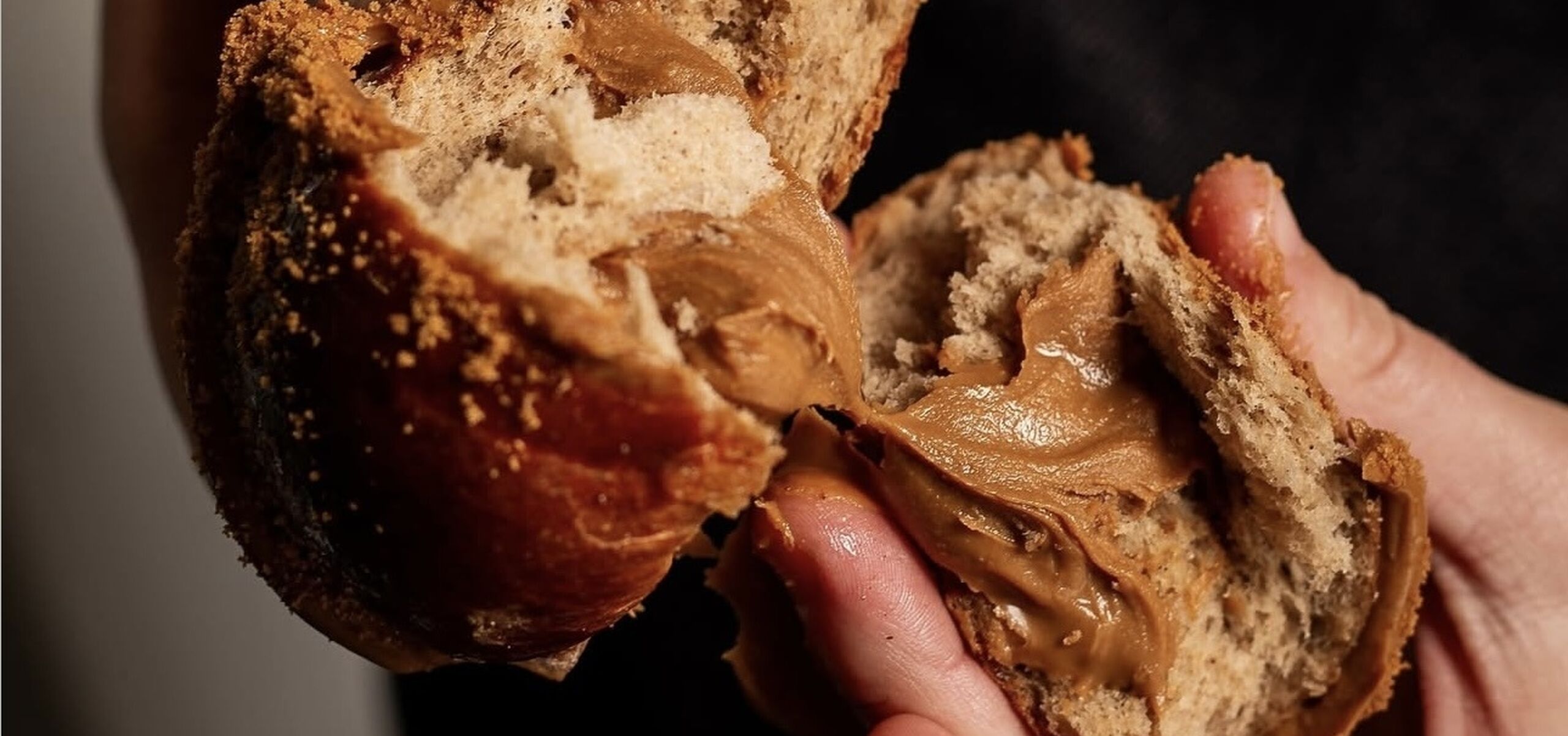 Biscoff Hot Cross Bun broken in half