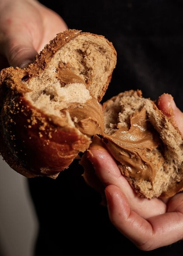 Biscoff Hot Cross Bun broken in half