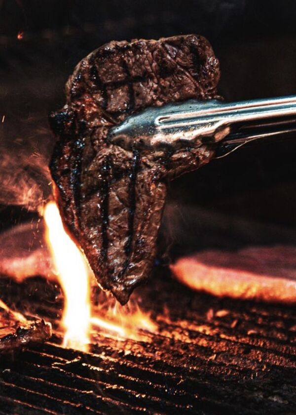 Steak being cooked on a BBQ