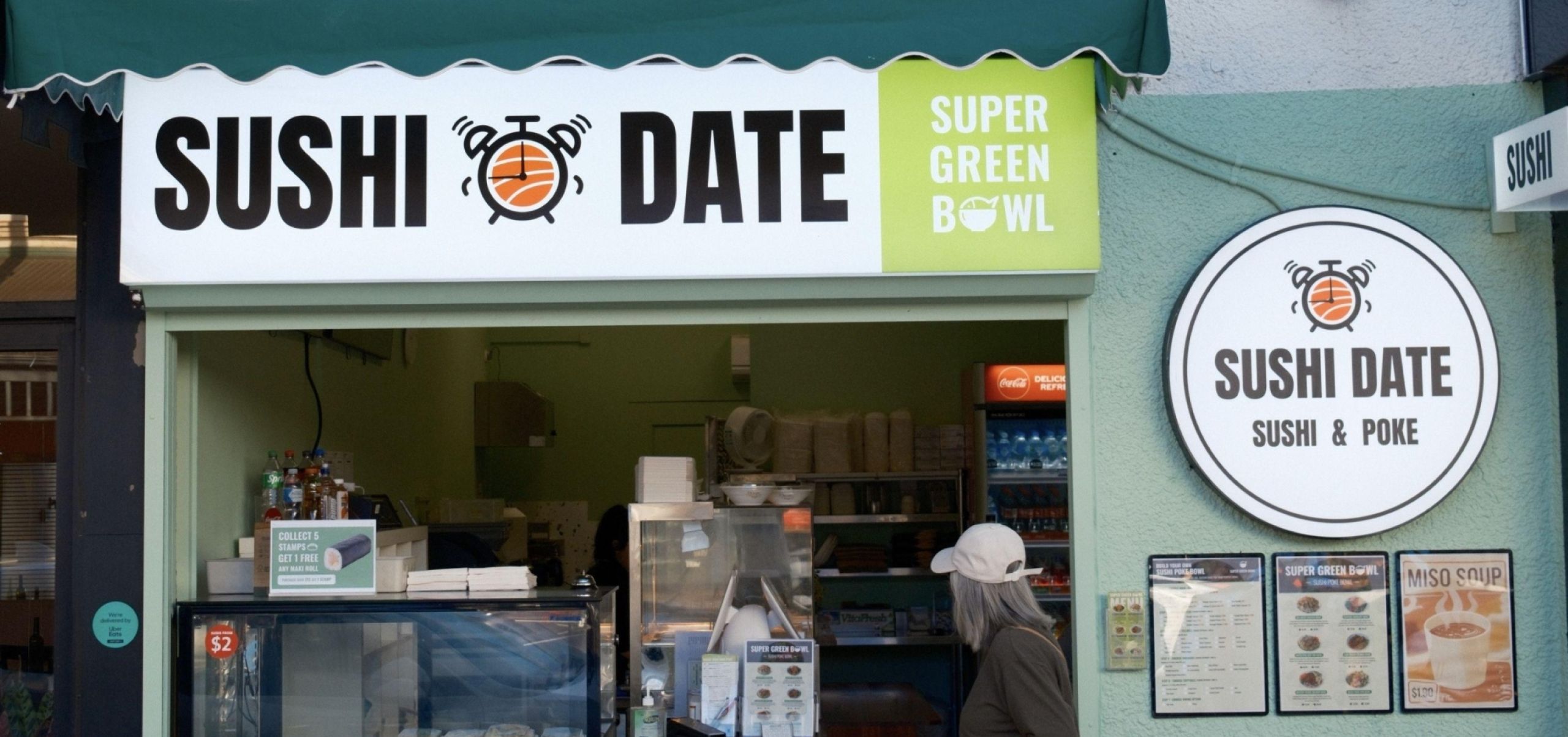 Person walking past sushi shop