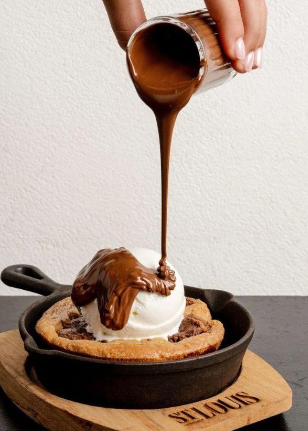 chocolate being poured on ice cream