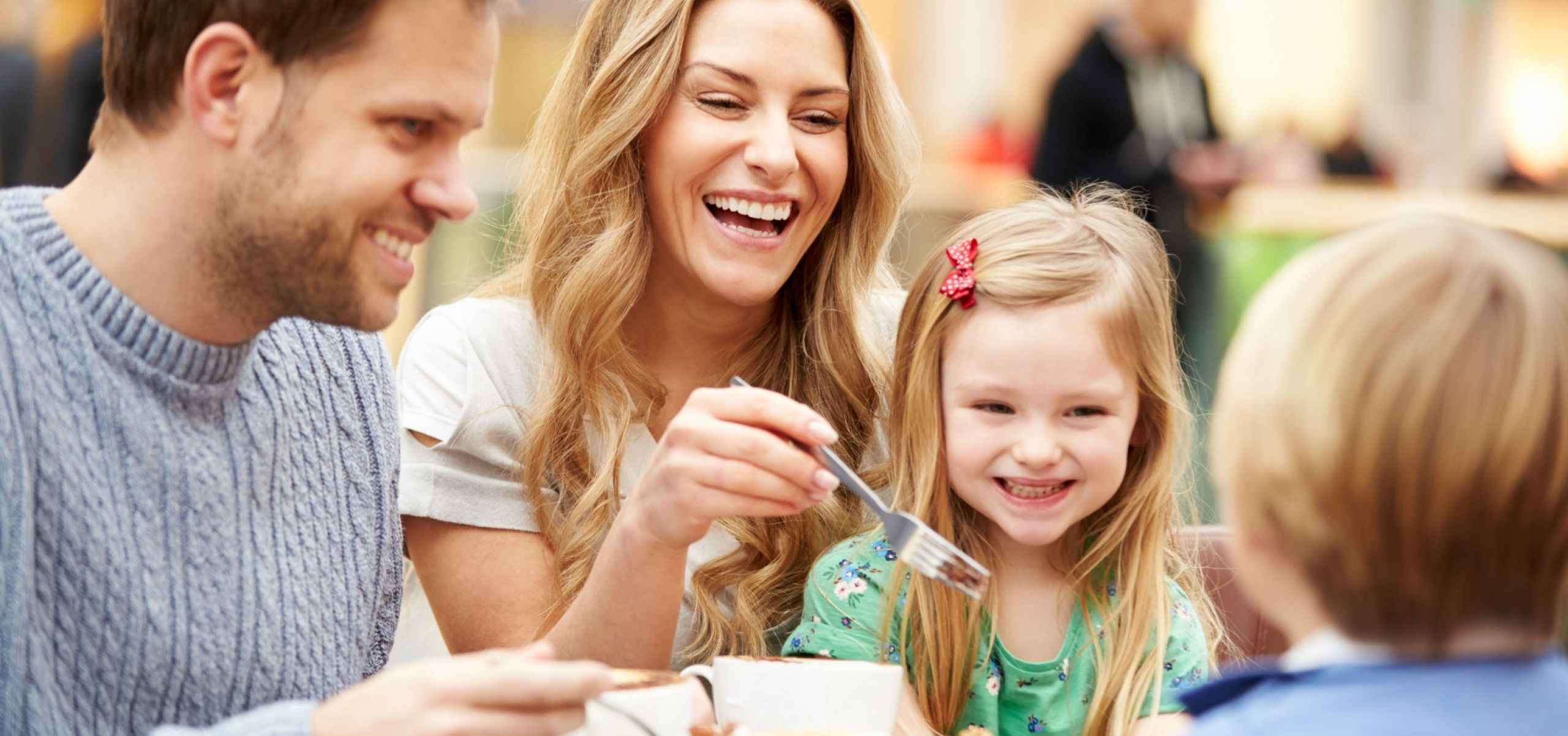 caucasian parents and children eating cake