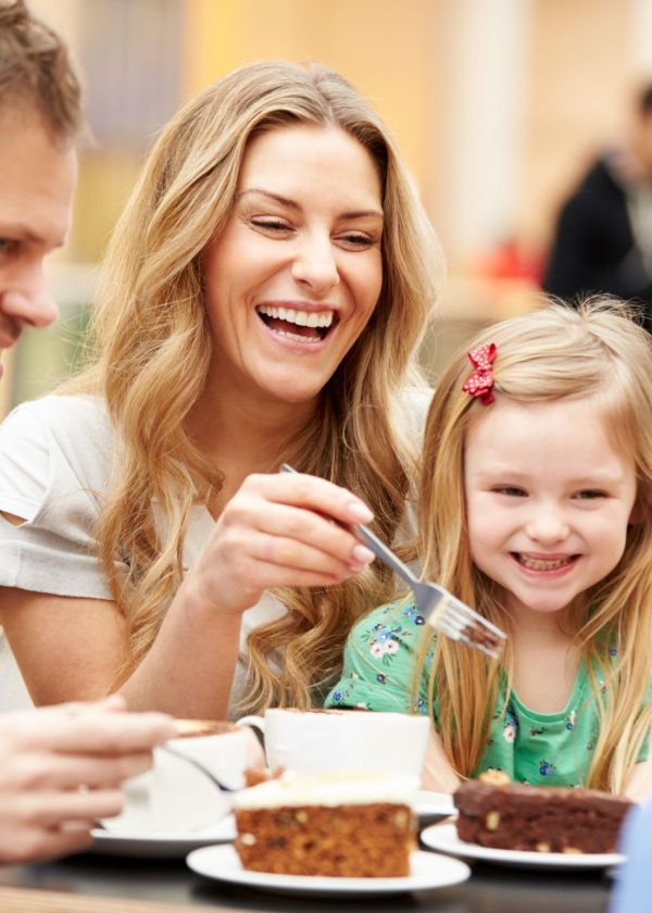 caucasian parents and children eating cake